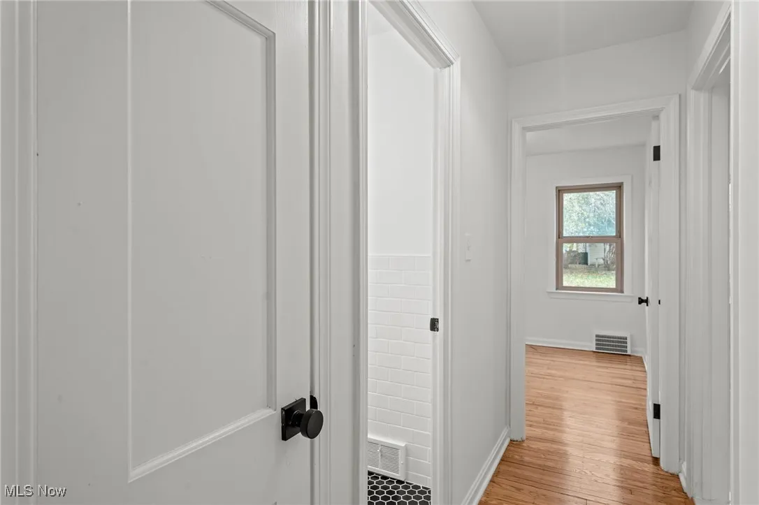 Hall with wood finished floors and baseboards
