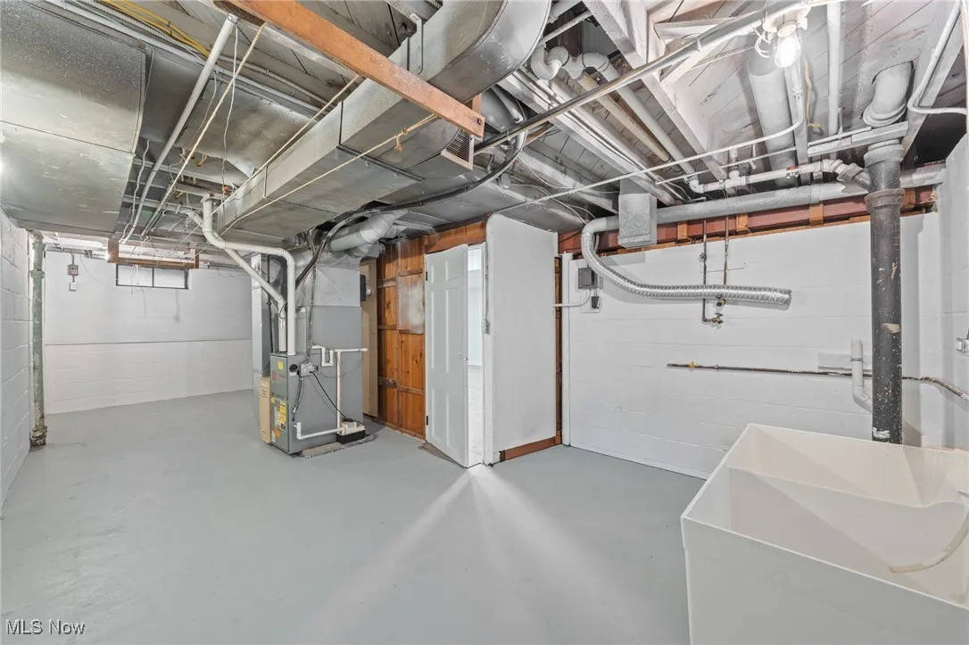 Below grade area featuring a sink and heating unit