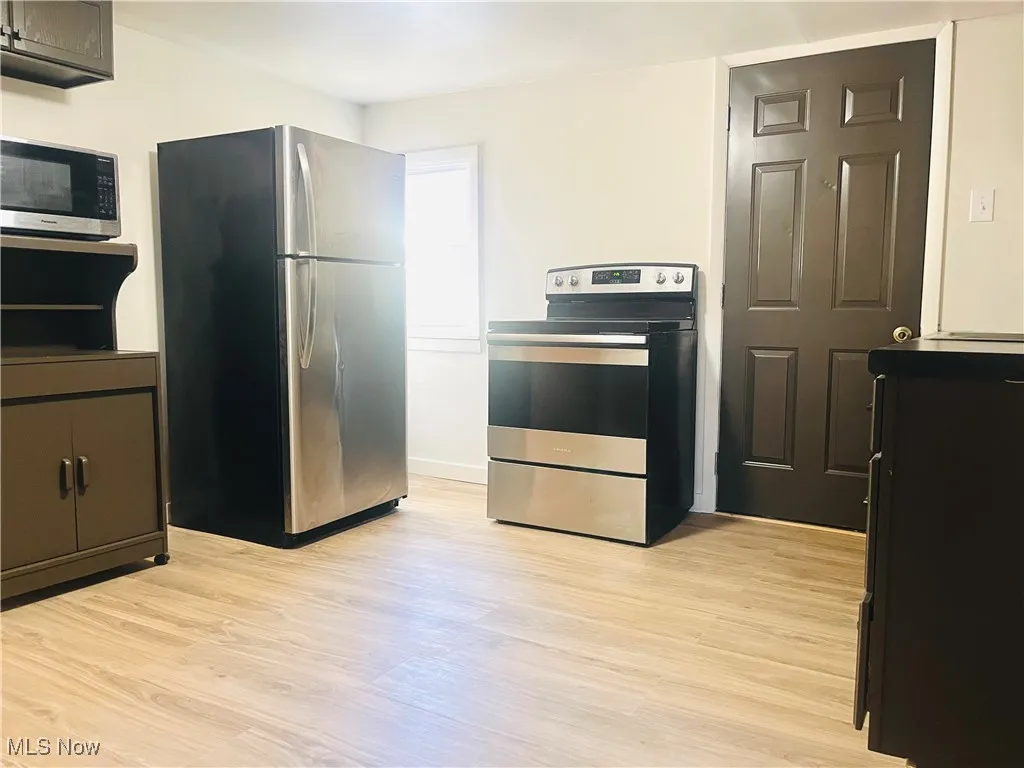 Kitchen with stainless steel appliances and light wood-type flooring