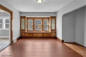 Unfurnished room featuring wood finished floors and baseboards
