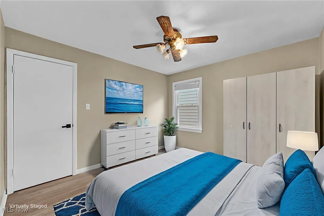 Bedroom featuring light wood-style flooring, a ceiling fan, and a closet