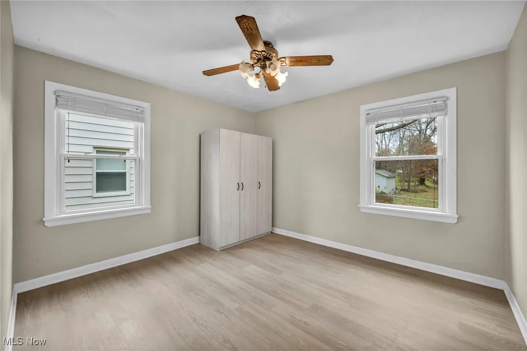 Unfurnished bedroom featuring light wood finished floors and a ceiling fan
