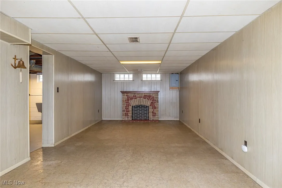 Finished rec room with faux fireplace