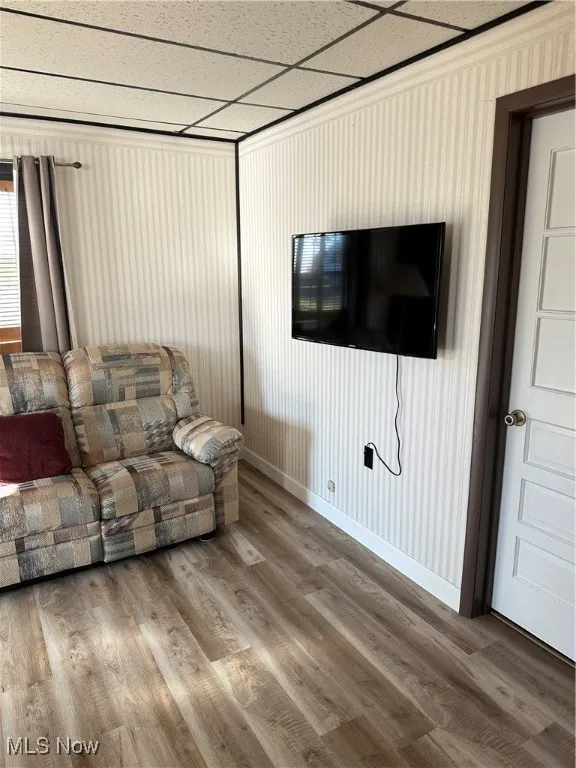 Living area with wood finished floors and baseboards
