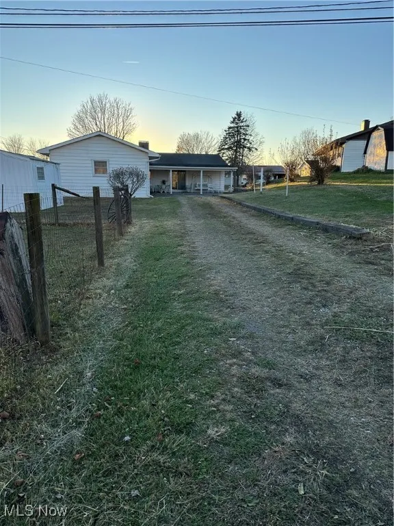 View of Back entrance of property showing the storage shed, garage and covered patio.