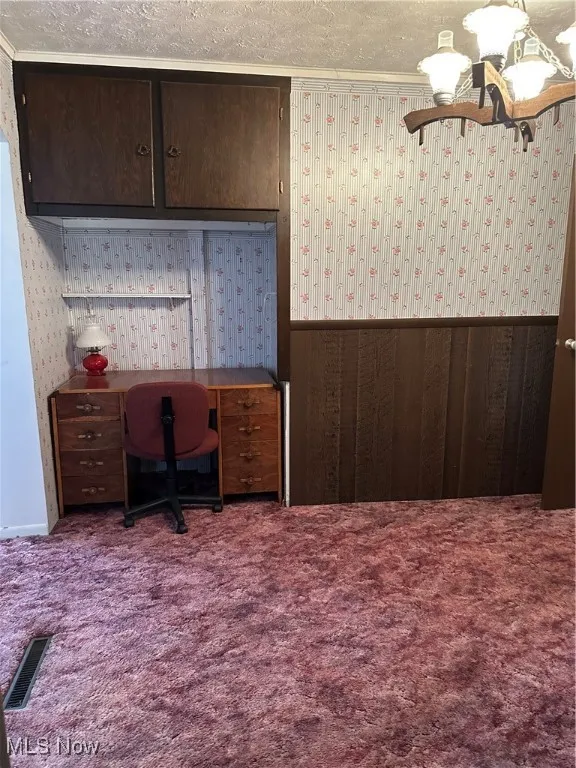 Office featuring carpet, wallpapered walls, a textured ceiling, a chandelier, and wainscoting
