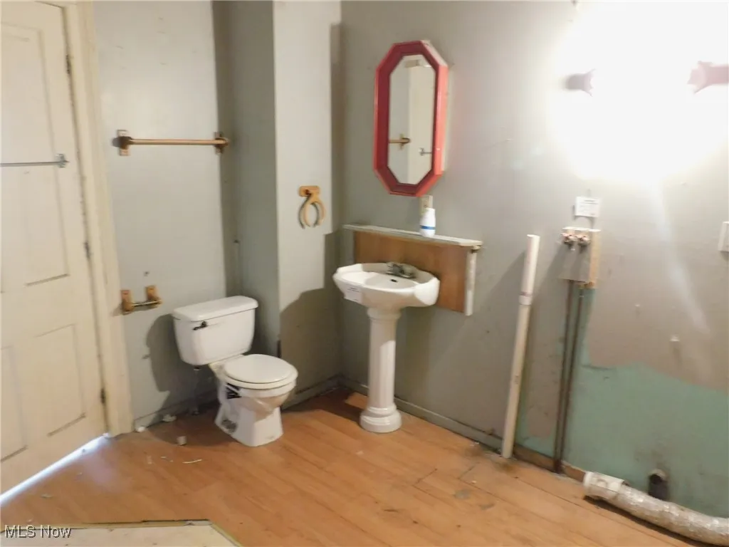 Bathroom 1 1st floor view B with light wood finished floors and toilet