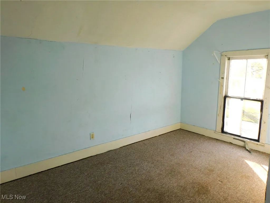 bedroom 3 up A  with carpet flooring and lofted ceiling