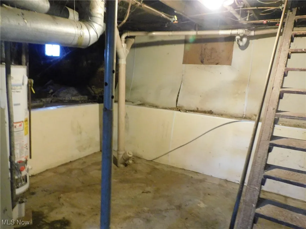 Unfinished basement view B  featuring stairway and water heater