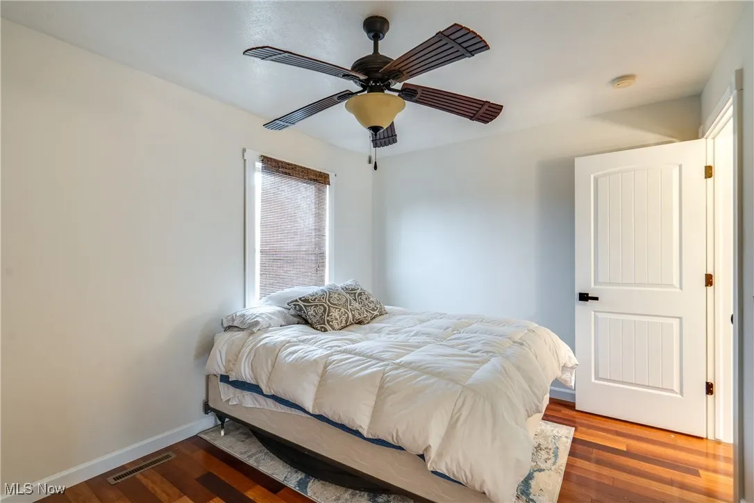 Bedroom featuring wood finished floors and ceiling fan