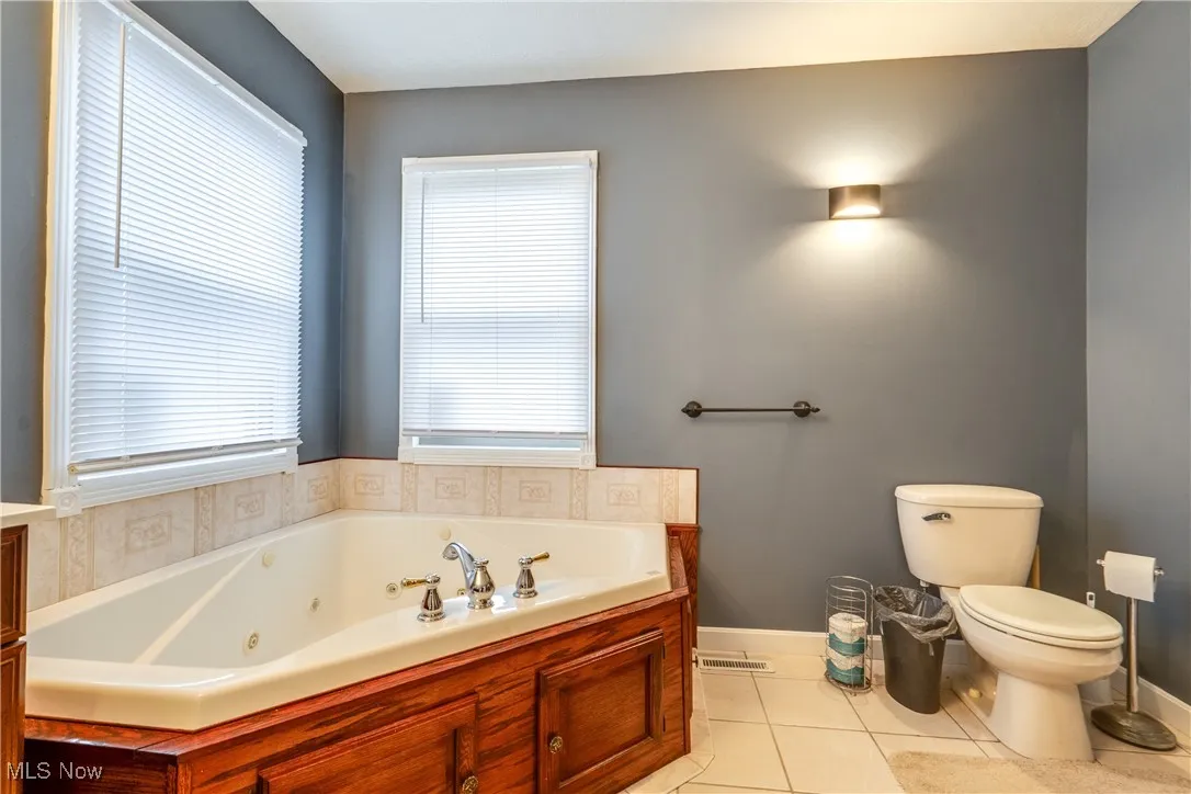 Bathroom featuring a jetted tub and light tile patterned floors