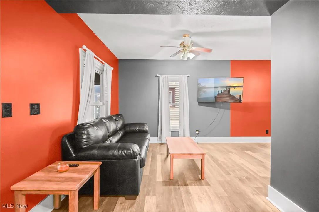 Living room featuring light wood-style floors and a ceiling fan