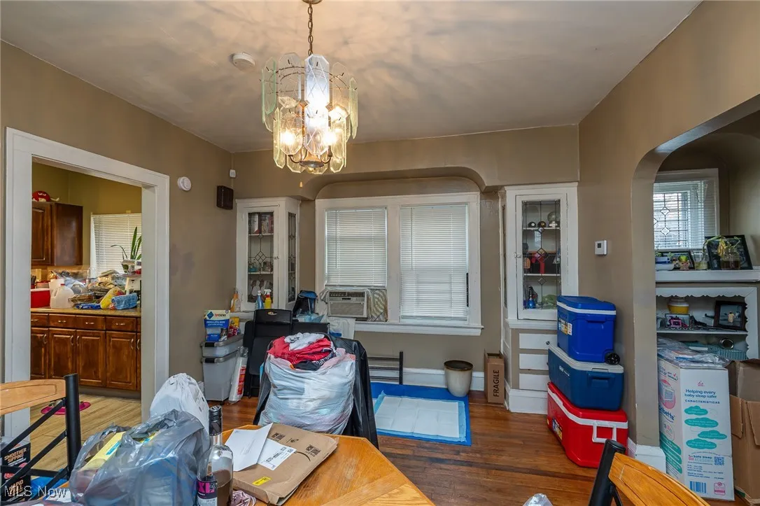 Dining space with wood finished floors and a chandelier