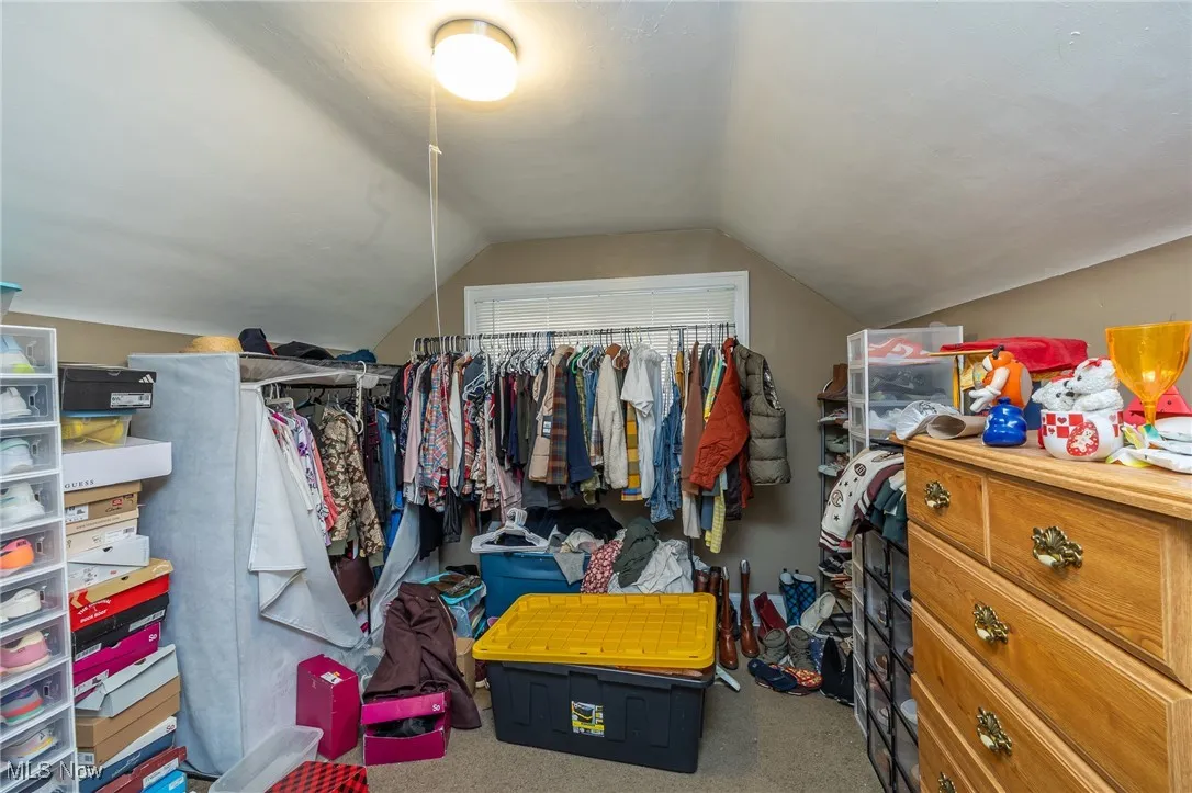 Walk in closet featuring carpet flooring and lofted ceiling