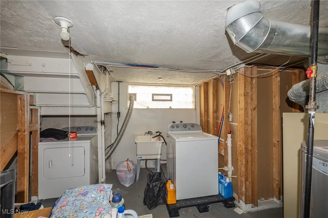 Washroom with independent washer and dryer and concrete floors