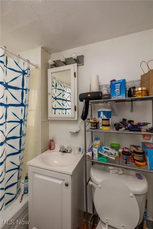 Full bathroom featuring vanity and shower / bath combination with curtain
