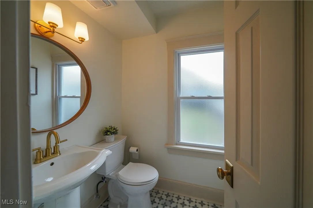 Updated first floor half bathroom with new marble floors