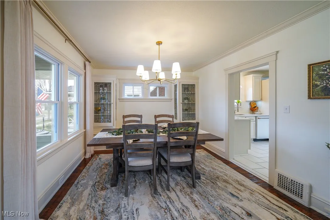 Dinning room with restored hardwood floors and beautiful built in storage.