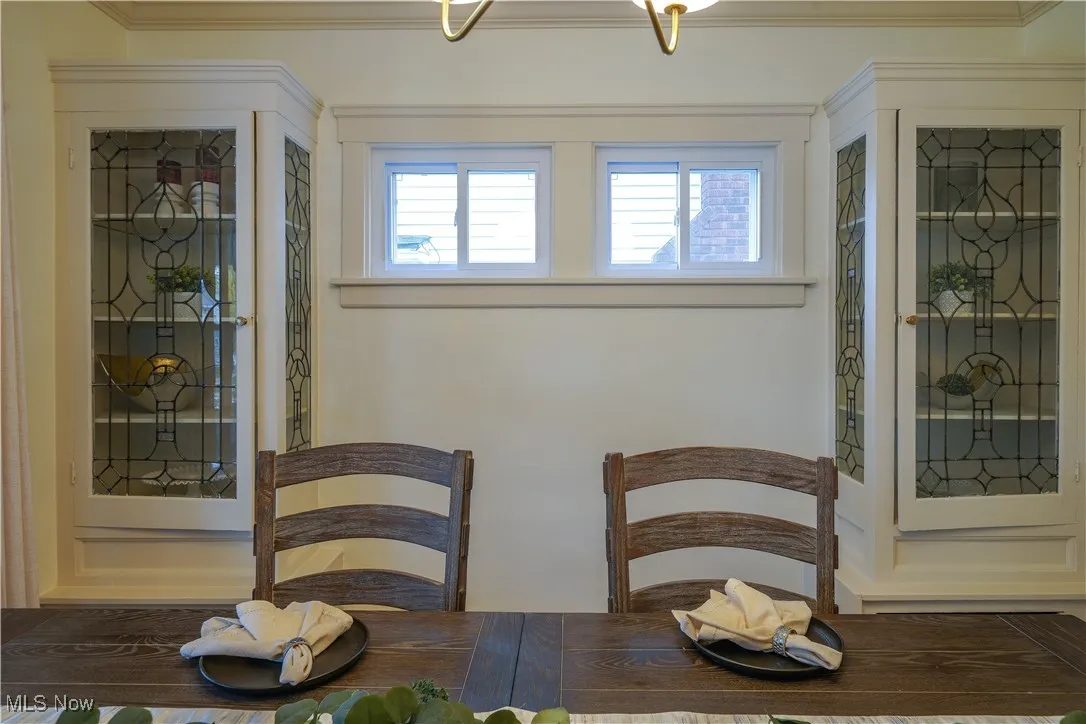 Beautiful glass built ins in this lovely dinning room.