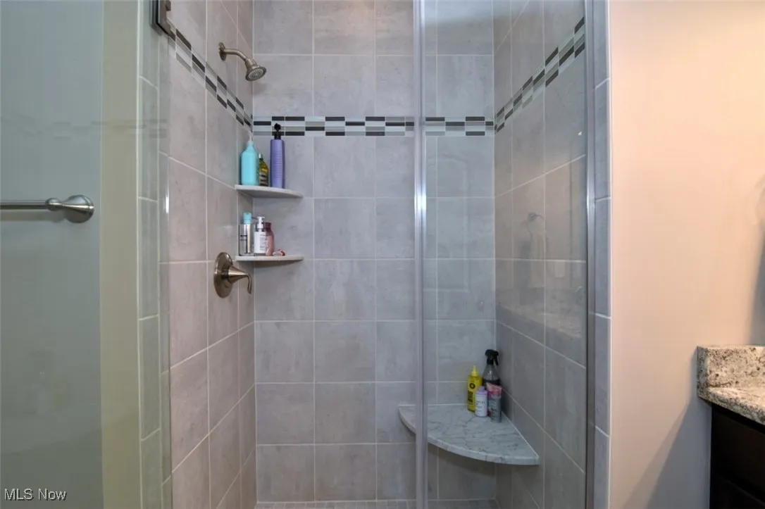 Bathroom featuring vanity and a stall shower