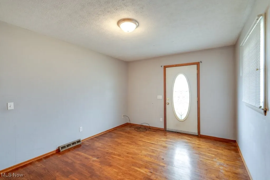 Entrance foyer featuring wood finished floors and a textured ceiling