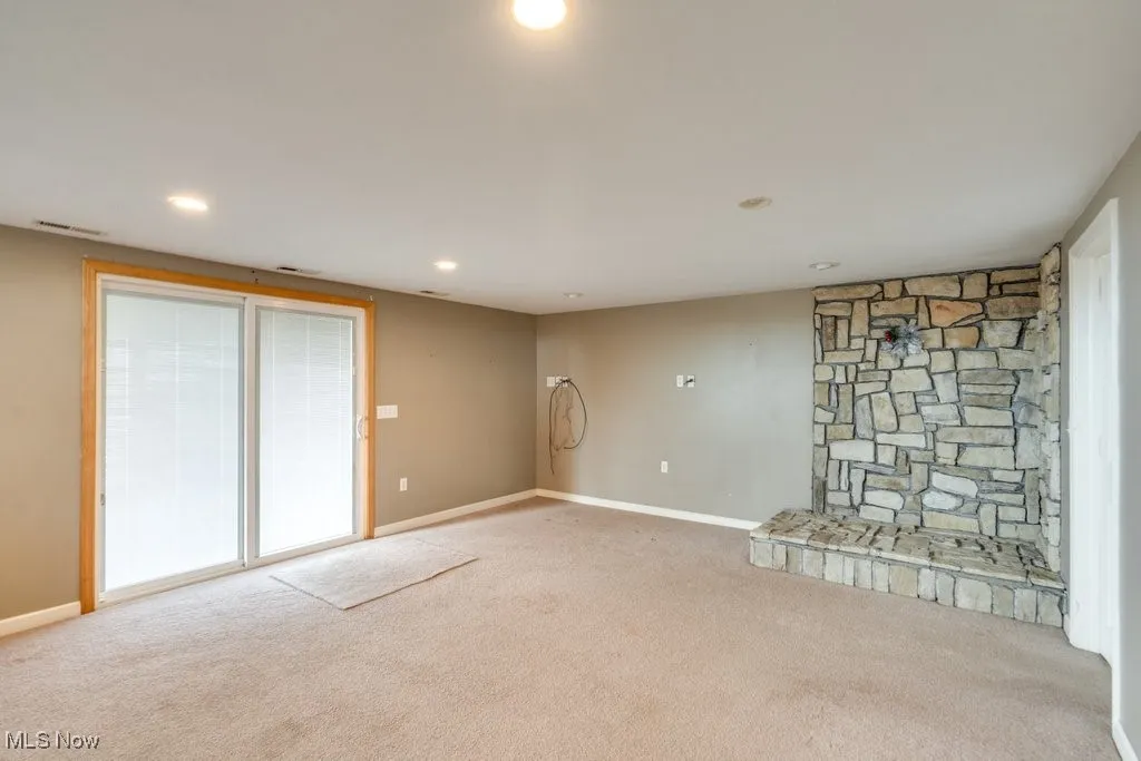 Unfurnished living room with carpet and recessed lighting
