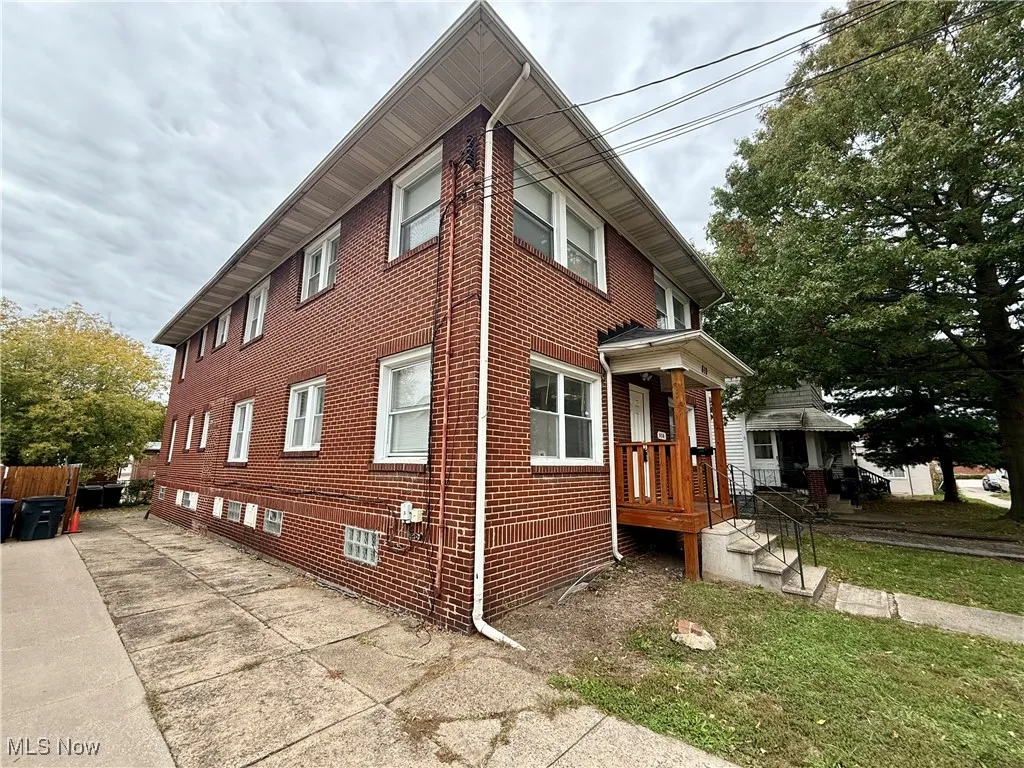 View of property exterior with brick siding