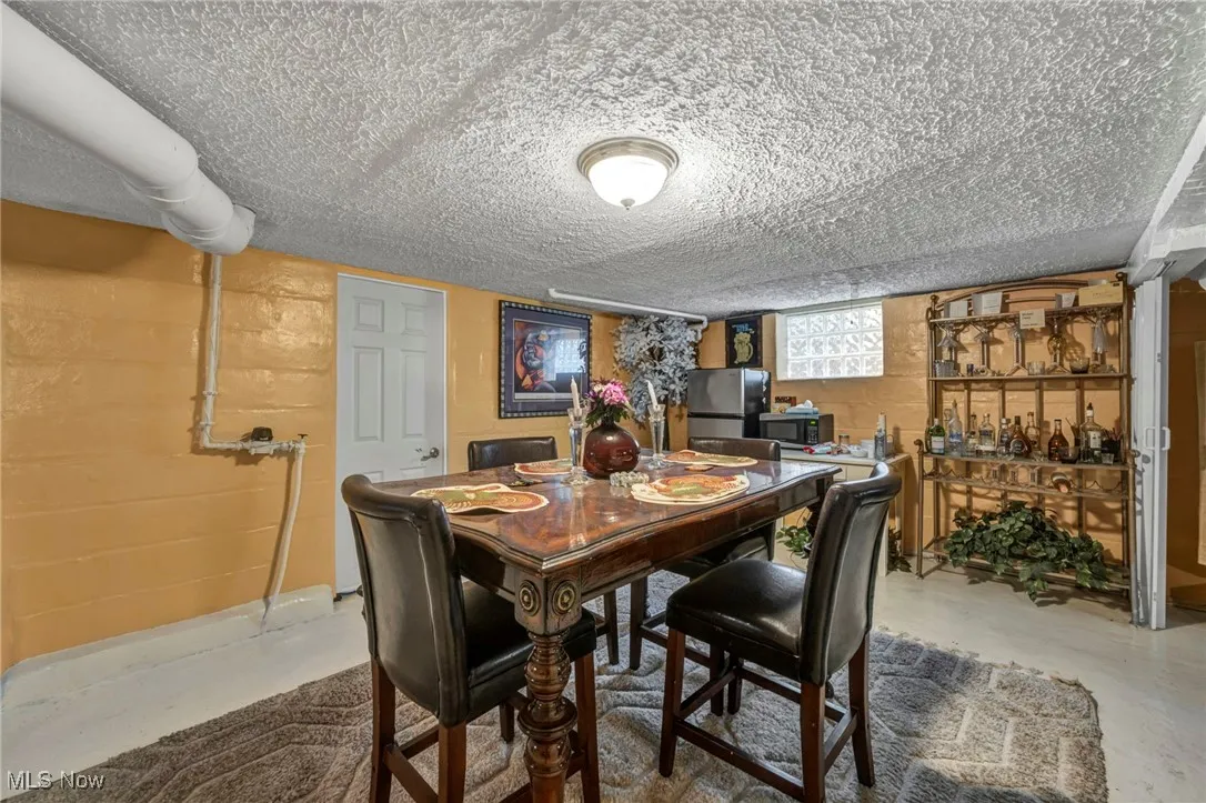 Dining space featuring finished concrete floors and wooden walls