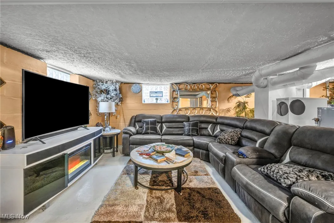 Living room with concrete floors and a textured​​‌​​​​‌​​‌‌​‌‌​​​‌‌​‌​‌​‌​​​‌​​ ceiling