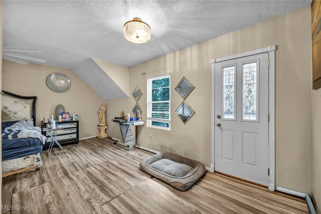 Entrance foyer featuring a textured ceiling and wood finished floors