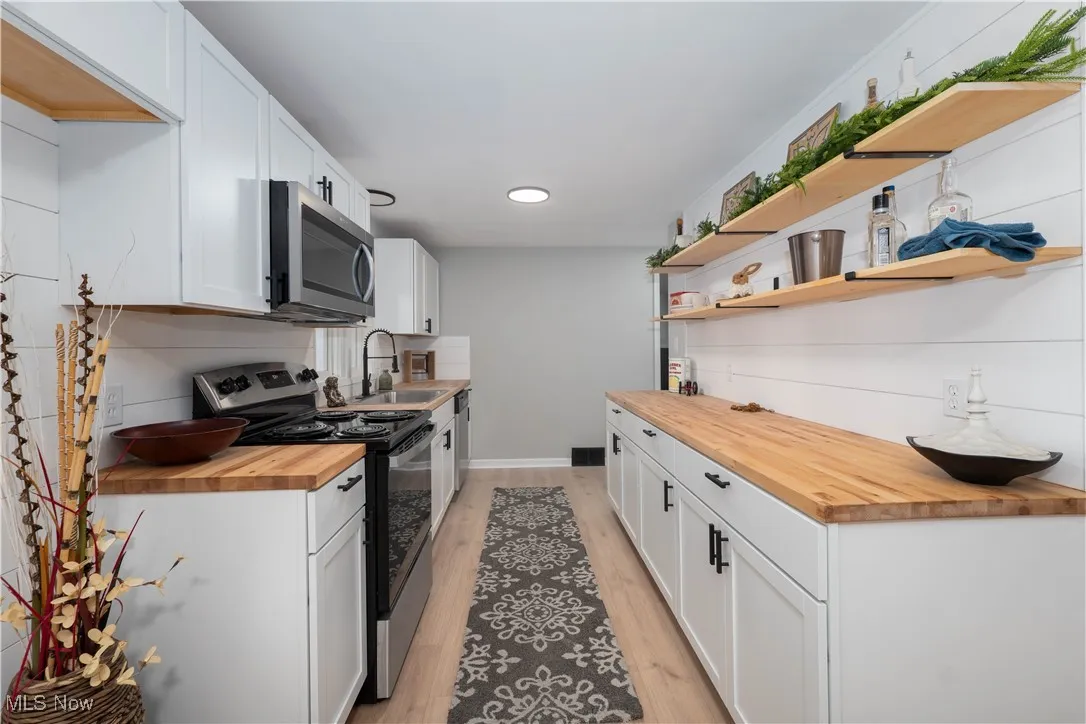 Kitchen featuring open shelves