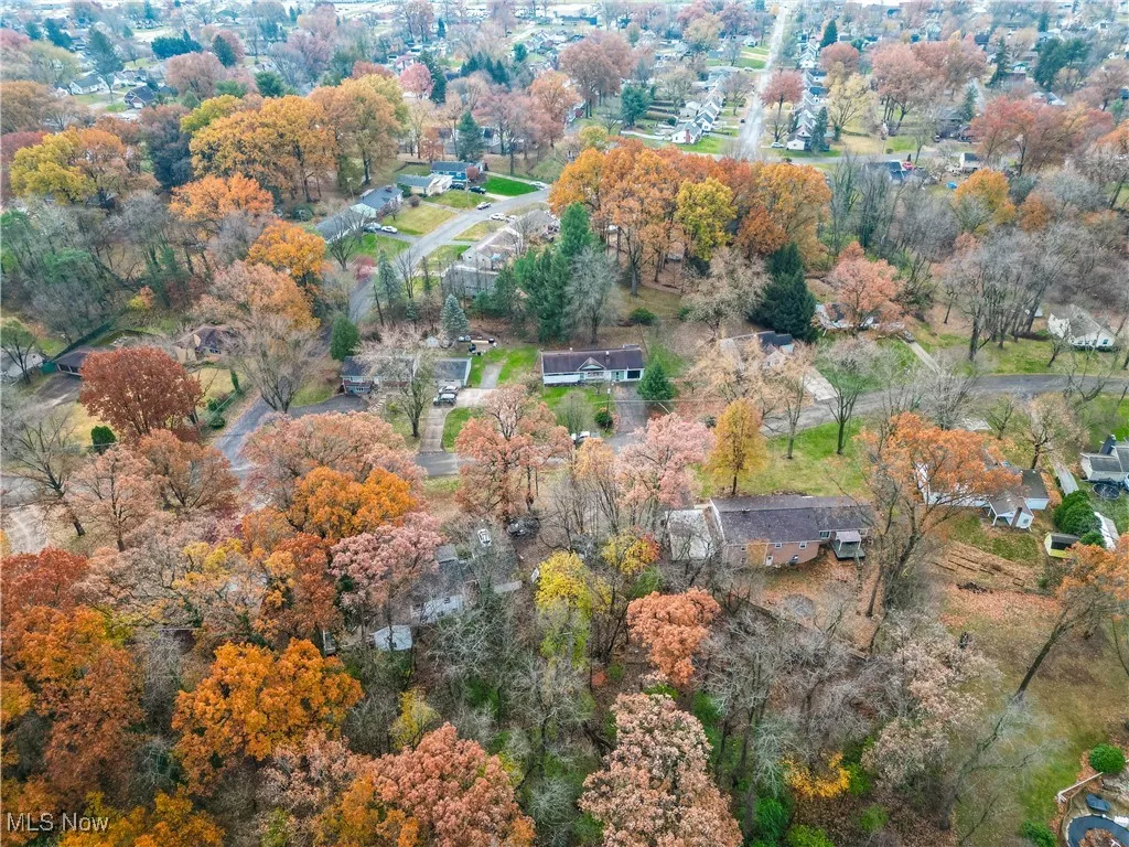 Aerial view of property's location with a tree filled landscape
