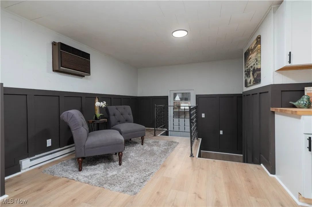 Bonus room featuring a decorative wall