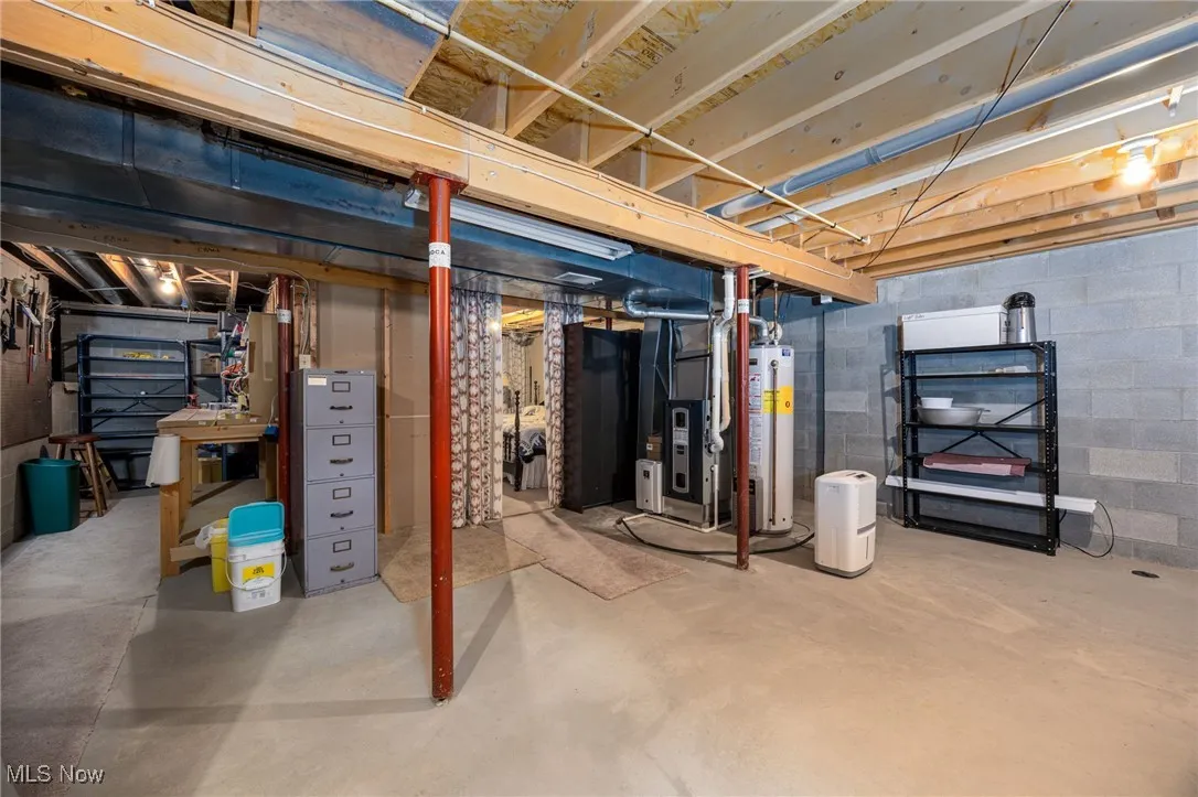 Unfinished basement with heating unit and gas water heater