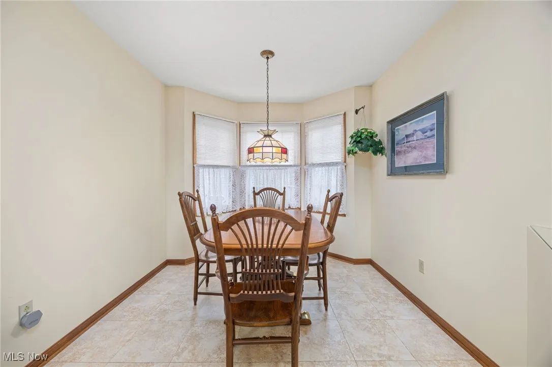 Dining area with baseboards and light tile patterned flooring