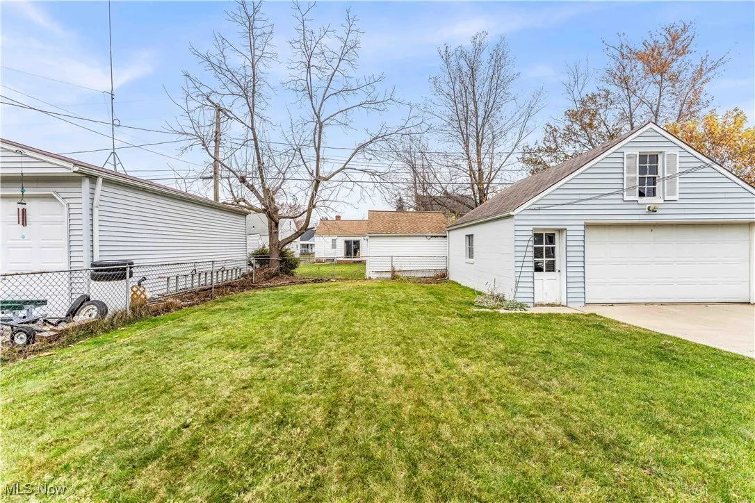 View of yard featuring an outbuilding and a detached garage