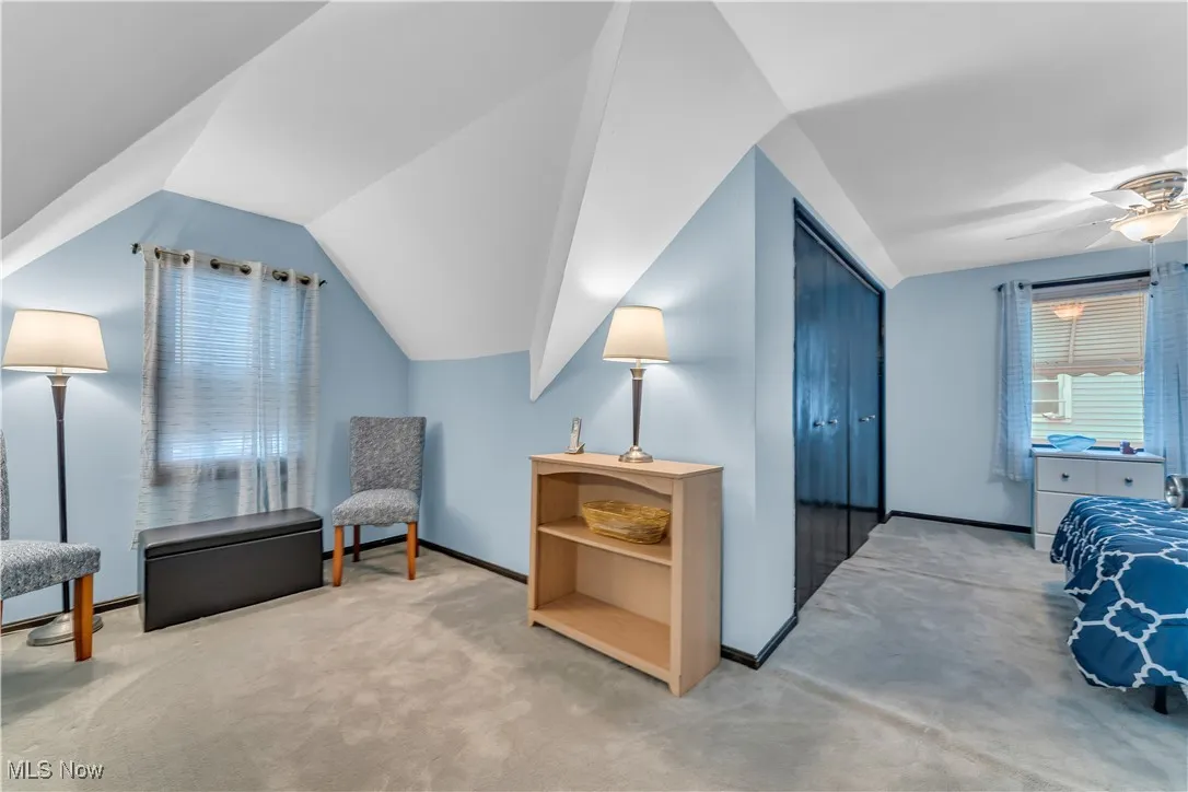 Sitting room with carpet floors, lofted ceiling, and a ceiling fan