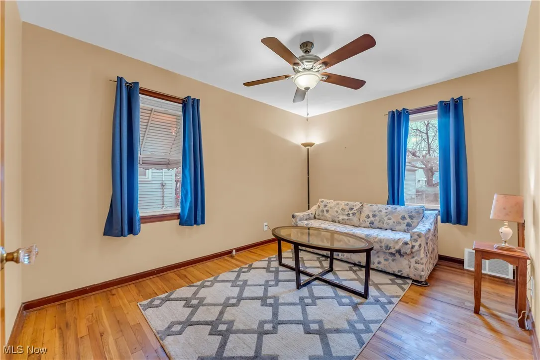 Living room featuring light wood-style flooring and a ceiling fan