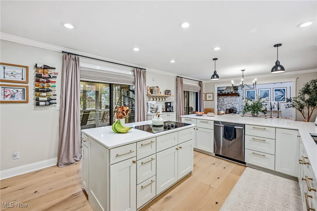 Kitchen has quartz countertops and built in appliances includeing wall range and dishwasher