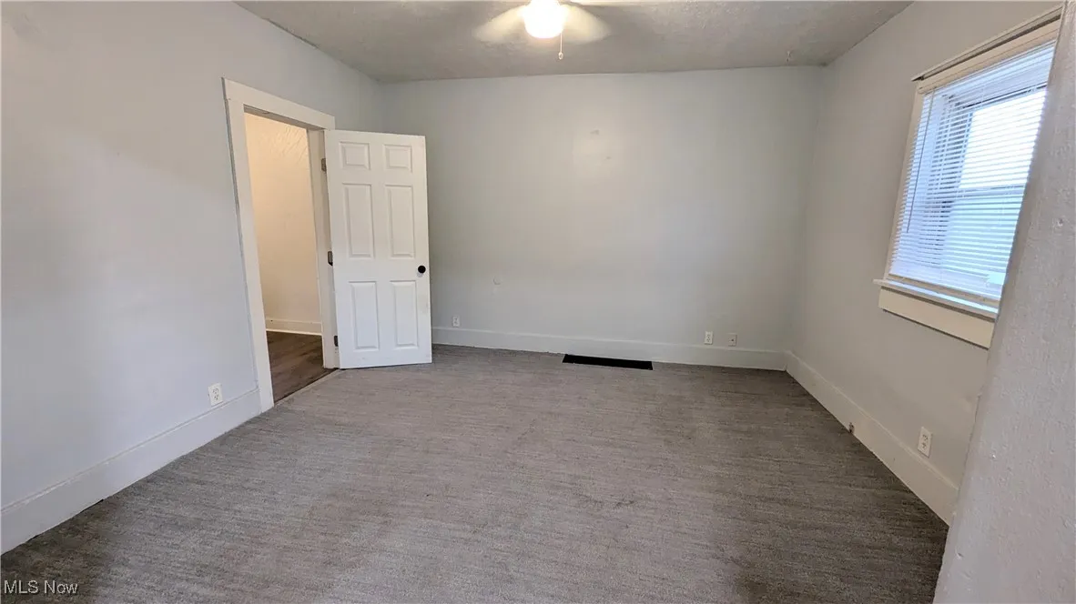 Living Room to the right of the front door. Open door leads to a first floor bedroom.
