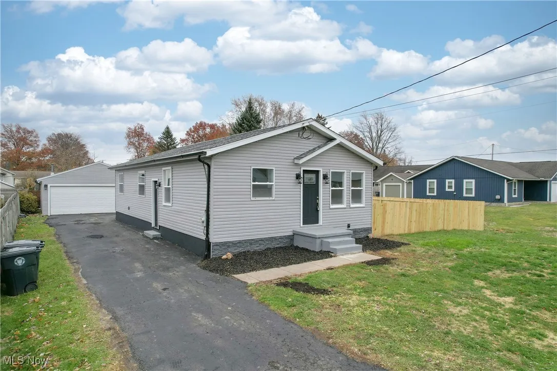 View of front facade with an outbuilding and a garage