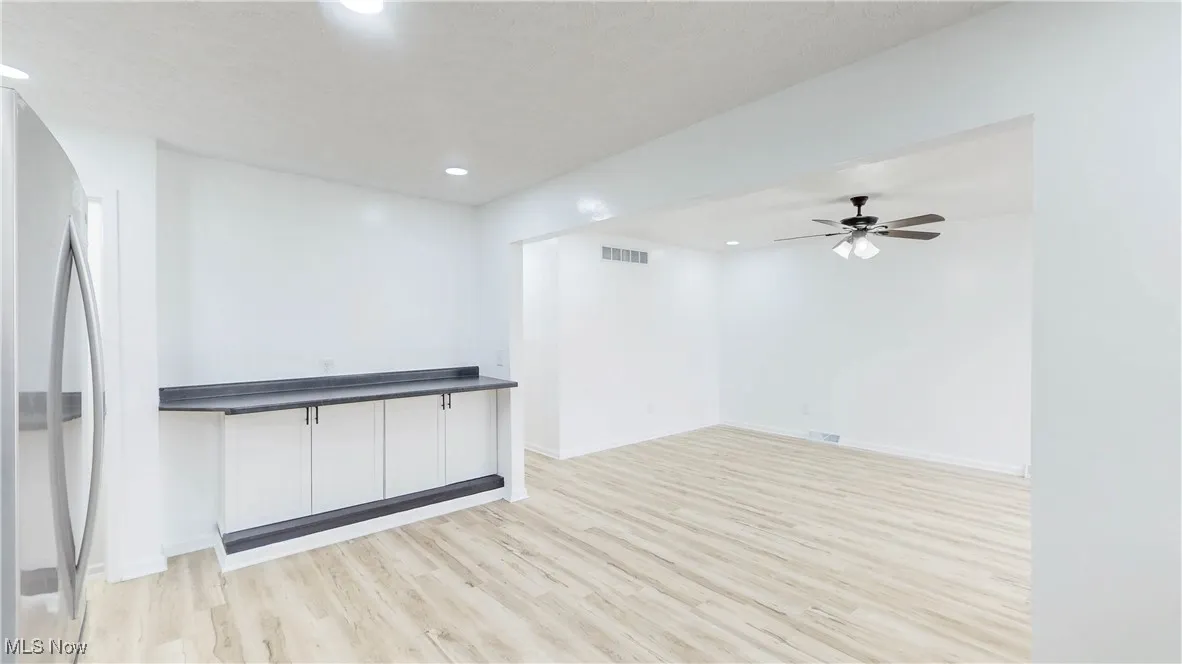 Unfurnished room featuring light wood-style flooring, a ceiling fan, and recessed lighting