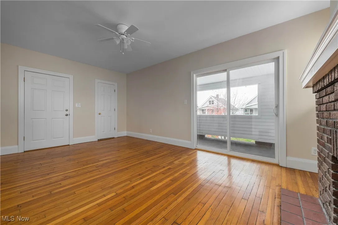 Unfurnished living room featuring light wood-type flooring and ceiling fan