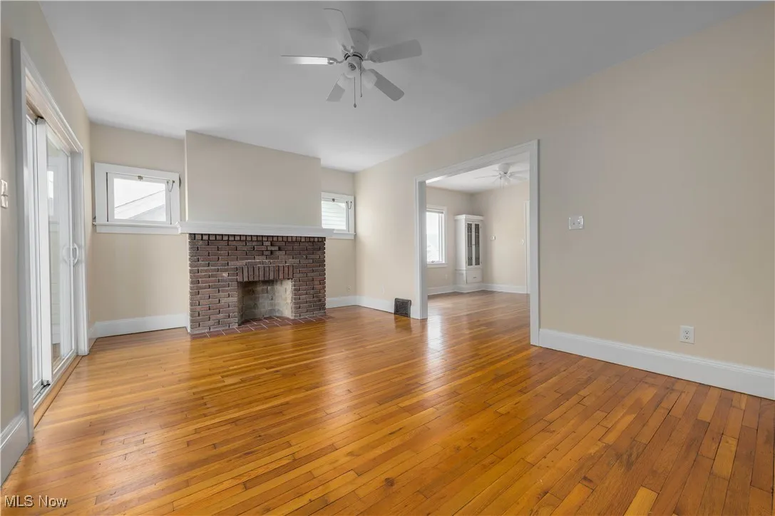 Unfurnished living room with light wood finished floors and a fireplace