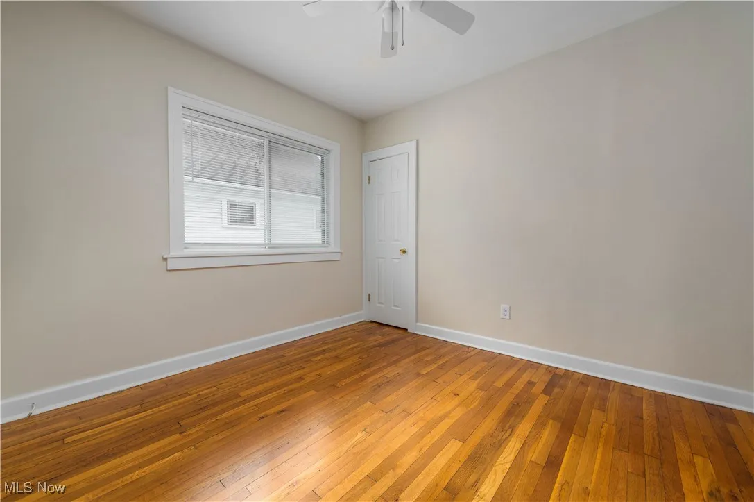 Empty room featuring wood-type flooring and baseboards