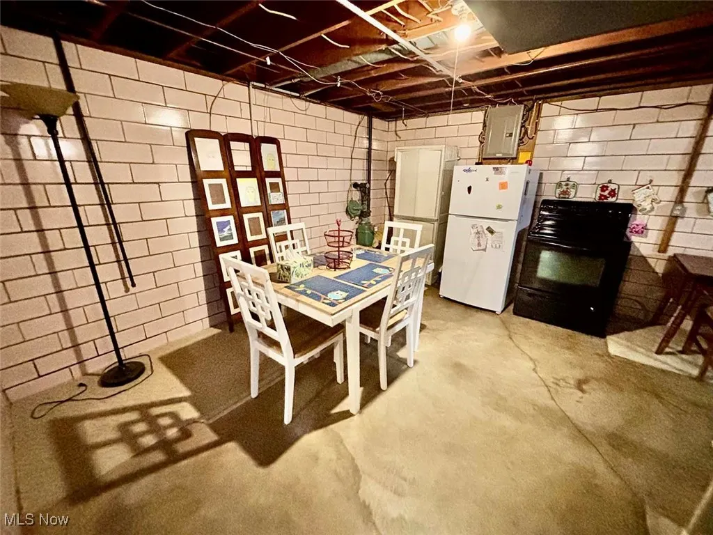 Basement featuring concrete floors and kitchen area