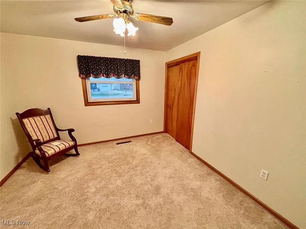 Third bedroom with carpet floors and a ceiling fan