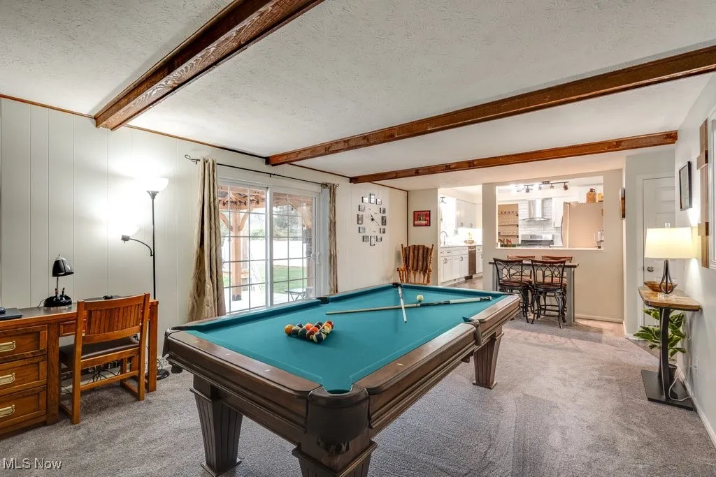 Game room with beamed ceiling, a textured ceiling, carpet, and pool table