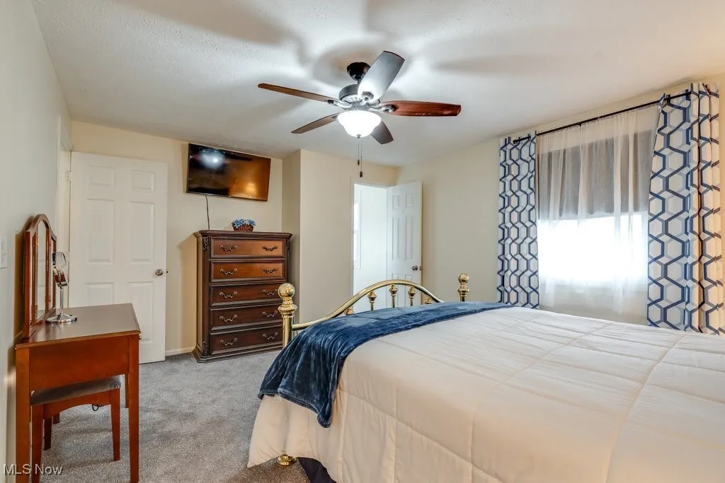Bedroom with carpet and a ceiling fan