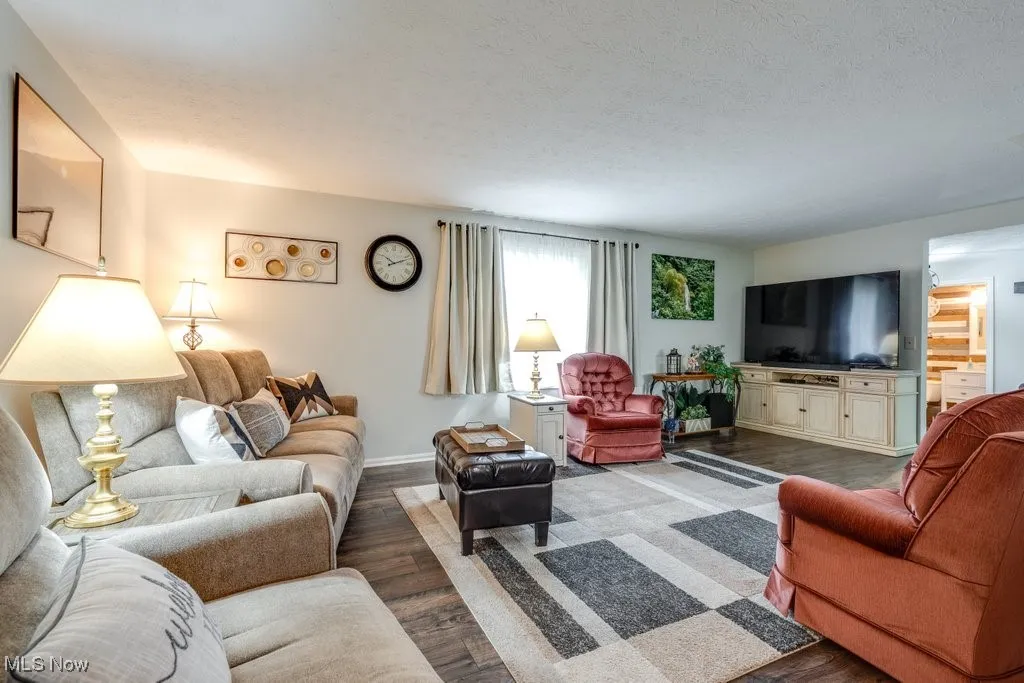 Living area with wood finished floors and a textured ceiling
